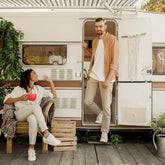 Couple enjoying full-time RV living with a cozy setup, highlighting the benefits of a reliable RV solar power system